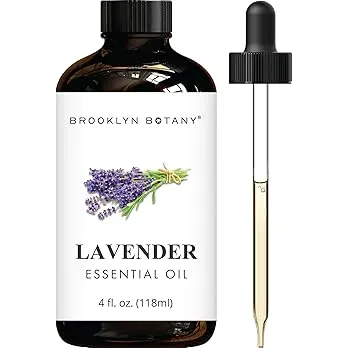 Bottle of lavender essential oil with lavender flowers in the background.